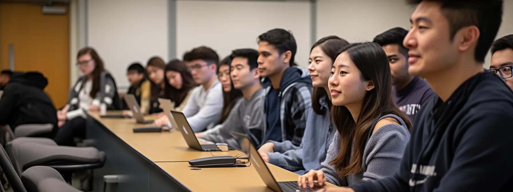a group of students in a classroom listening attentively to an seo instructor.