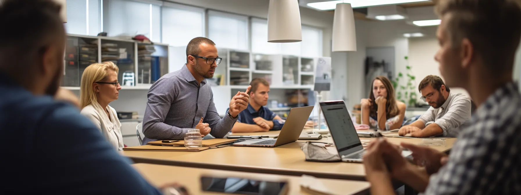 a group of people in a classroom, engaged in a discussion about seo trends and strategies with an seo expert.