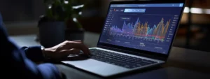 a laptop with google analytics 4 interface on the screen and a person analyzing data.