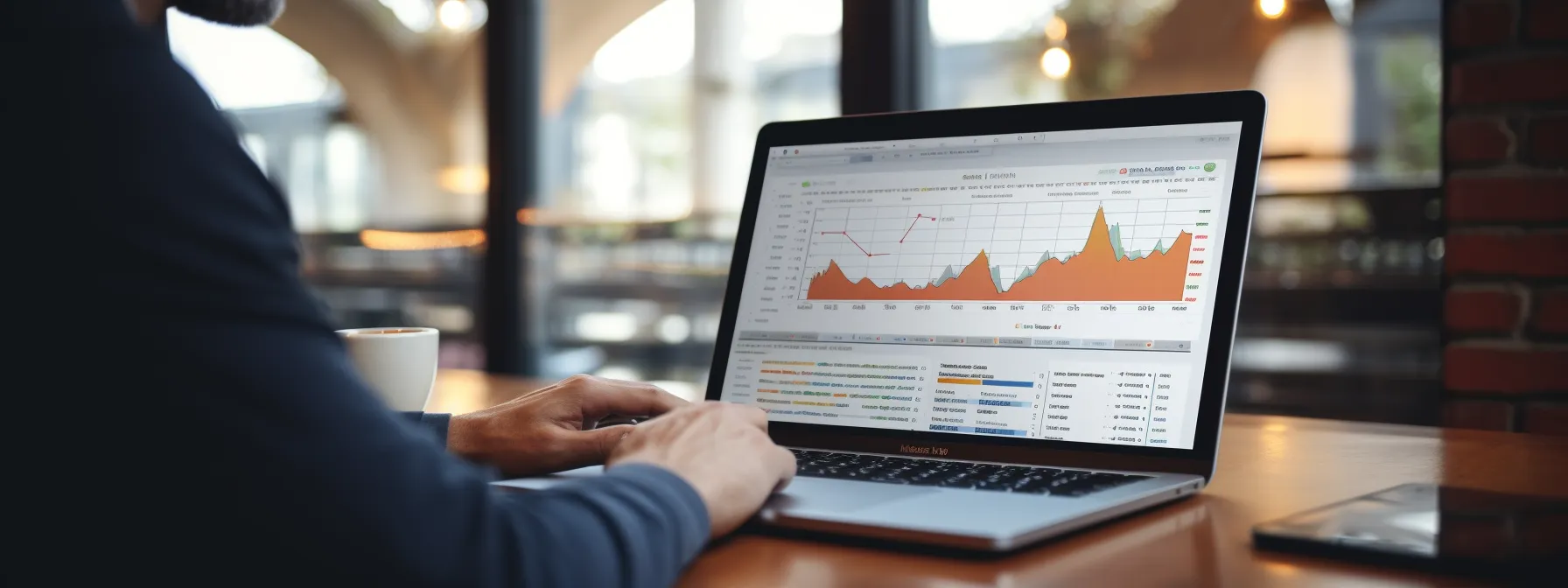 a person intensely studying a detailed google analytics report on a laptop screen.